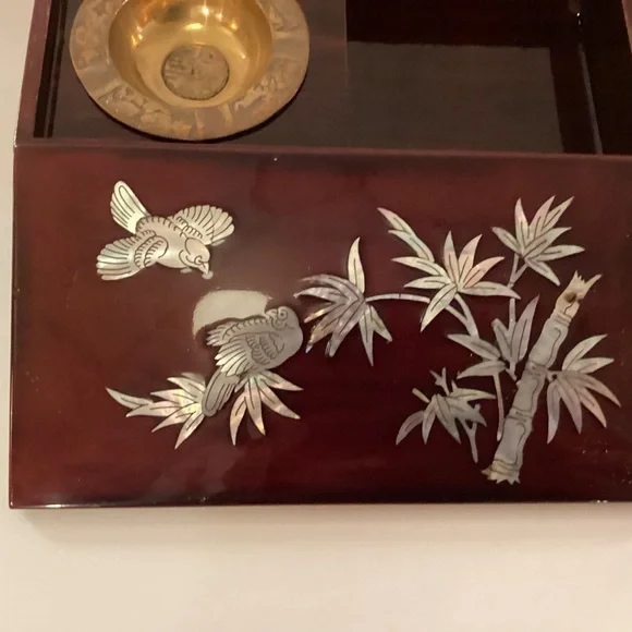 Vintage lacquered smoking box with mother of pearl inlay.